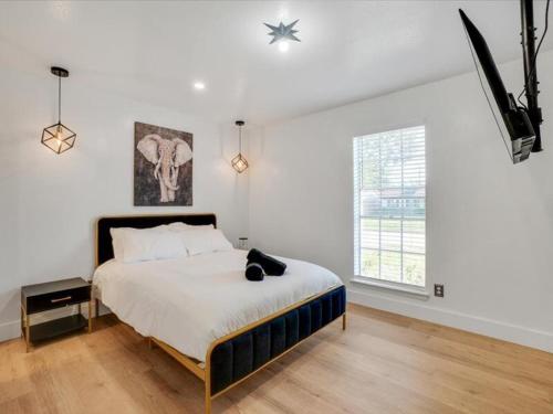 a bedroom with a bed and a television in it at Holiday 4BR 2BA Home with Pool, Hot Tub, Fire Pit in Irving
