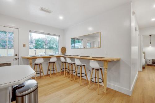 a kitchen with a bar with stools and a mirror at Holiday 4BR 2BA Home with Pool, Hot Tub, Fire Pit in Irving