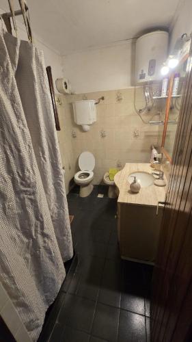 a bathroom with a toilet and a sink at La Casa de Lili in La Pedrera
