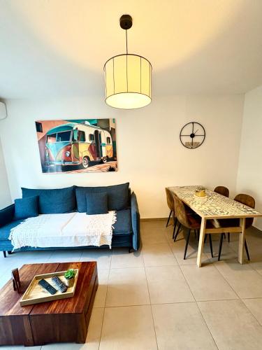 a living room with a couch and a table at Charmant appart. 3-4 pers. in Saleilles
