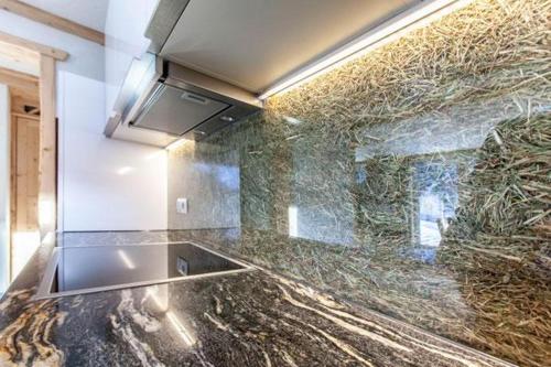 a kitchen with a granite counter top and a counter top at Casa de Wisa in Gaschurn