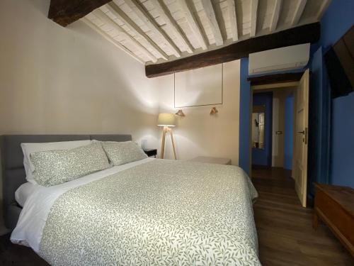 a bedroom with a white bed and blue walls at LuccaStay 99 in Lucca