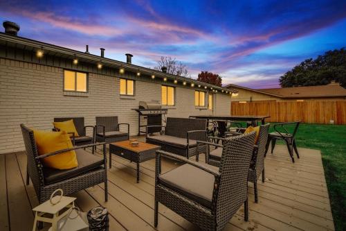 a patio with wicker chairs and tables and a grill at Upscale 3BR 2BA Cozy Holiday Home with Pool & Grill in North Richland Hills