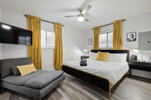 a bedroom with a bed and a couch at Upscale 3BR 2BA Cozy Holiday Home with Pool & Grill in North Richland Hills