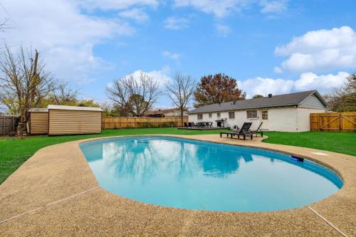 a swimming pool in the backyard of a house at Upscale 3BR 2BA Cozy Holiday Home with Pool & Grill in North Richland Hills