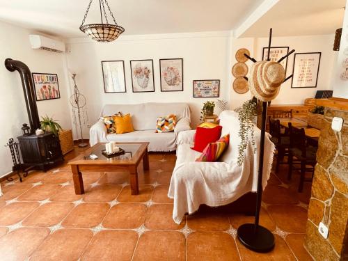 a living room with a couch and a table at Villa EMMA - Chalet familiar con jardín y parking en Málaga in Málaga