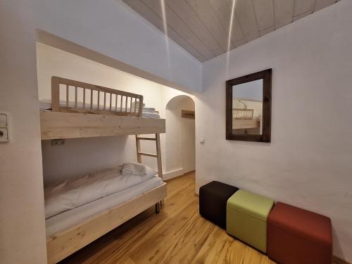 a small room with a bunk bed and a mirror at Apartment Peacock - Steinbock Lodges in Zell am See