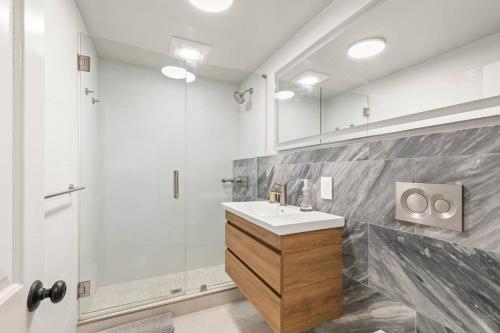a bathroom with a sink and a shower at Stunning Bay Views | Beach Access - Deck - Parking in Provincetown