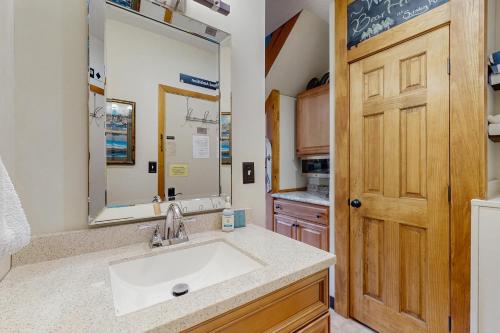 a bathroom with a sink and a large mirror at Fall Line W212 in Newry