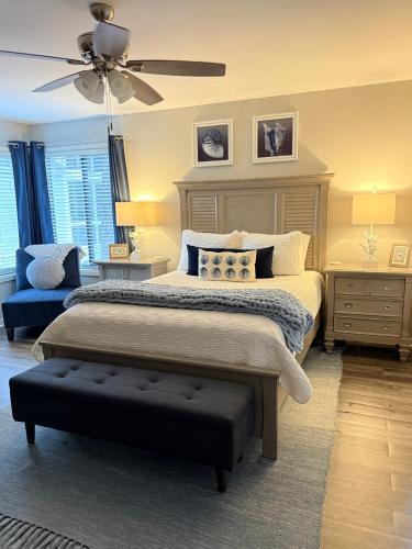 a bedroom with a bed and a ceiling fan at Boutique Coastal Retreat in Edisto Island
