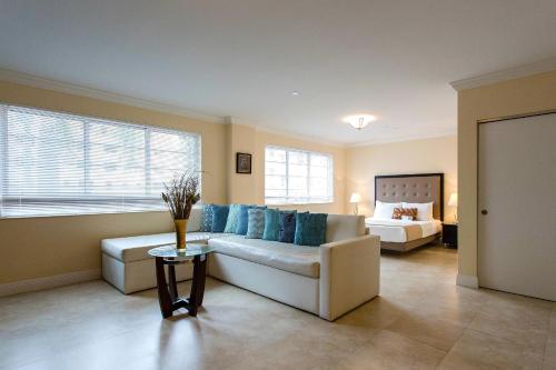 a living room with a couch and a bed at Westover Arms Hotel in Miami Beach