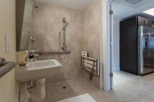 a bathroom with a sink and a shower at Westover Arms Hotel in Miami Beach