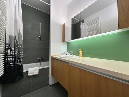 a bathroom with a sink and a shower at Prime Apartmans in Balatonlelle