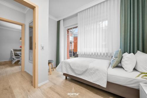 a bedroom with a bed and a large window at Ferienwohnung Hummer Büsum in Büsum