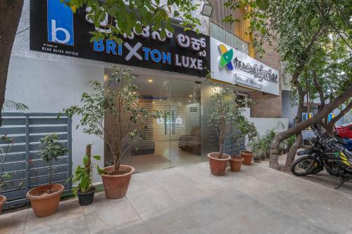 a store with a bunch of plants in front of it at Treebo Brixton Luxe in Bangalore