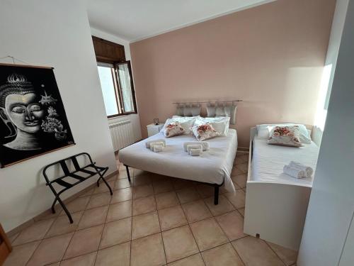 a room with two beds and a chair in it at Salento Casa Vacanza Il Focolare in Torchiarolo