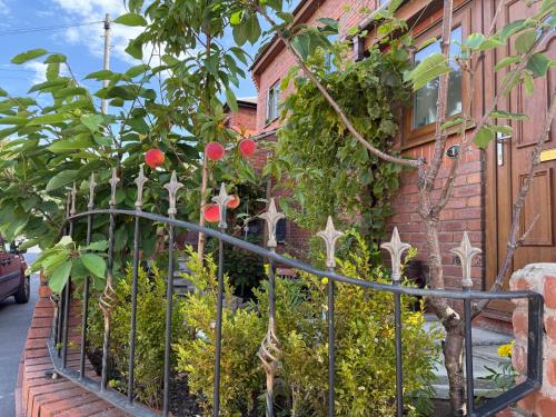 a fence in front of a building with plants at BFamily-Jacks Court in Stalybridge