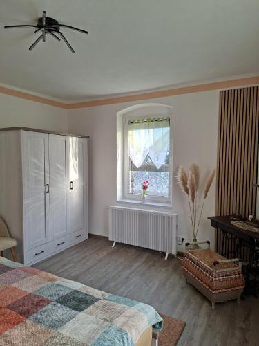 a bedroom with a bed and a window at FeWo LoBec 2 in Calau