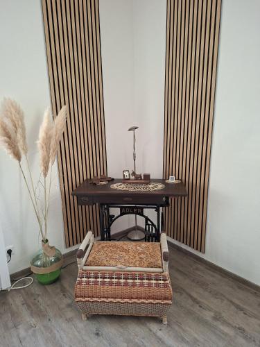 a table with a chair and a table with a stool at FeWo LoBec 2 in Calau