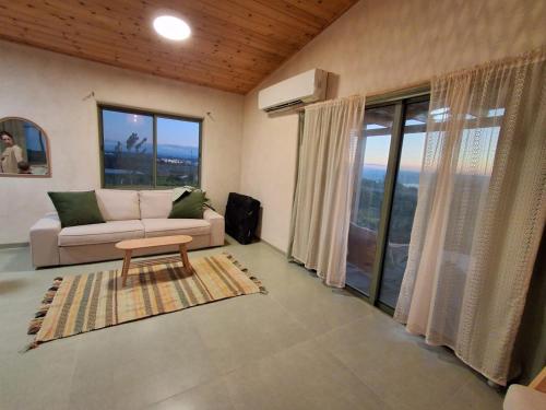 a living room with a couch and a table at שיר ערש in Giv'at Yo'av