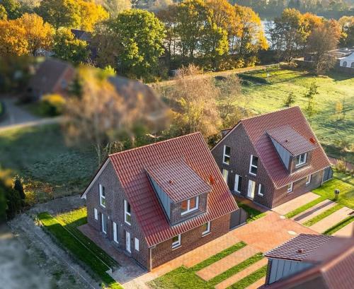 an aerial view of two houses with red roofs at Ferienwohnung Ebbe in Tannenhausen