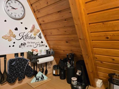 a kitchen with a clock on the wall and a counter at Haus Stern Carolinensiel in Carolinensiel