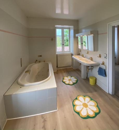 a large bathroom with a tub and a sink at Maison au coeur de Guéthary in Guéthary