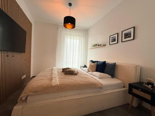 a bedroom with a large bed and a television at Elcami Living in Fritzens