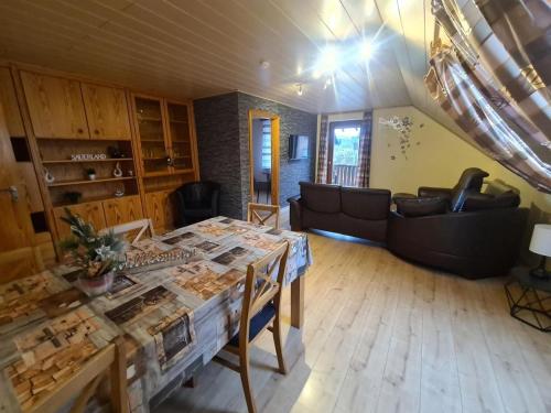 a living room with a table and a couch at Fewo Perle Medebach in Medebach