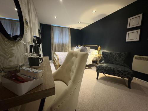 a bedroom with a bed and a table and chairs at The Old Farmhouse in Bristol