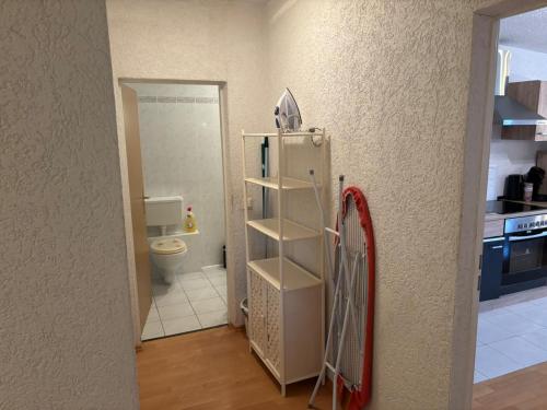 a kitchen with a refrigerator and a toilet in a room at Apartmenthaus - Mackenbach in Mackenbach