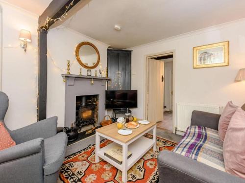 a living room with a couch and a fireplace at 1 Bed in Tenterden oc-66342 in Tenterden