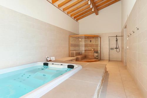 a bath tub in a bathroom with a shower at ORUE BASERRIA en Urdaibai in Muxika