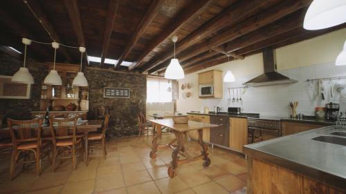 a kitchen with a table and a dining room at Casa La Monja in Garachico