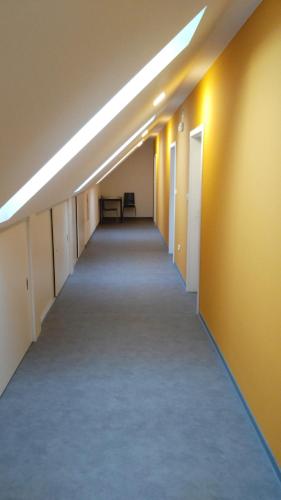 an empty hallway in an office building with lights at Bed & Parking Eurobit in Hrušky