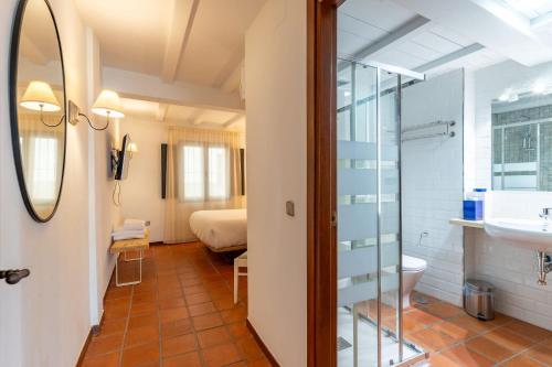 a bathroom with a toilet and a sink at Natural&Mente Apartamentos Valle del Jerte in El Torno