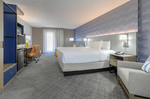 a hotel room with a large white bed and a couch at Comfort Inn & Suites at Dollywood Lane in Pigeon Forge