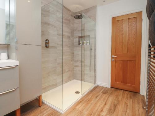 a shower with a glass door in a bathroom at Seaside Serenity in Lytham St Annes
