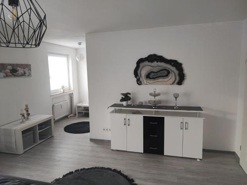 a white kitchen with a sink and a counter at Sweet Home in Hameln