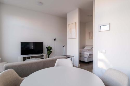 a living room with a couch and a tv at Modern One Bedroom Apartment - Rotterdam West in Rotterdam