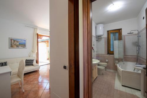 a bathroom with a tub and a toilet and a sink at Villa Gioiello in Amalfi