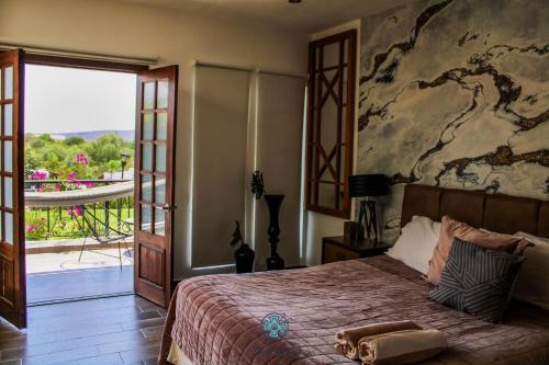 a bedroom with a bed with a painting on the wall at Yolihuani Relax Resort in Calvillo
