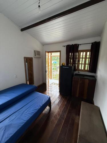 a bedroom with a bed and a table in it at Kit net great price in São Sebastião