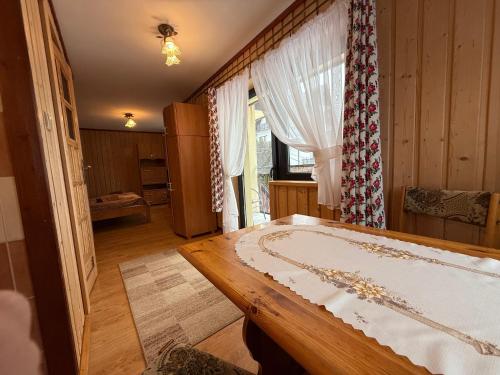 a bedroom with a large bed and a window at Pokoje Janka Gliczarów Górny in Gliczarów