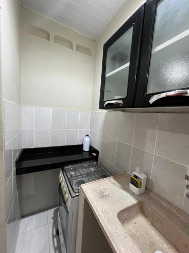 a small kitchen with a stove and a window at Estação 48 in Castanhal
