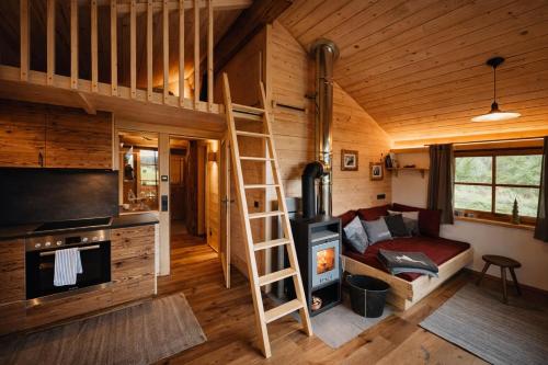 a loft bed in a tiny house with a fireplace at Chalet Herbst in Lofer