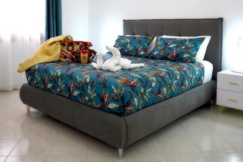 a bed with a white stuffed animal sitting on it at L'arco Sul Mare in Balestrate