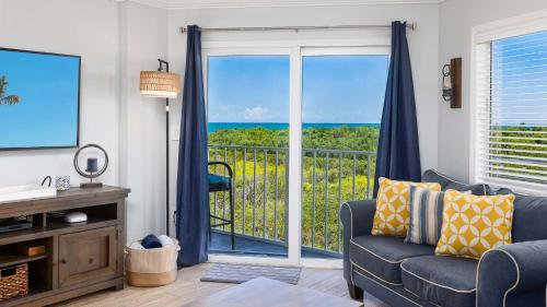 a living room with a couch and a view of the ocean at Saltair Loft Ocean Pointe 2 BR 2 BA 1411 in Tavernier