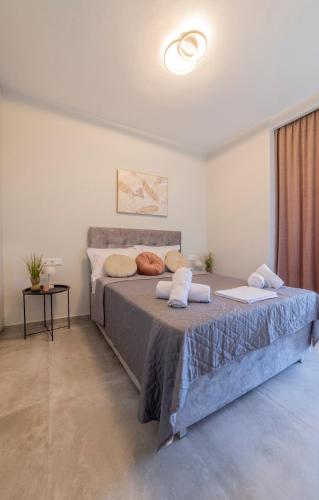 a bedroom with a large bed with two pillows on it at Peace Home Trikala in Tríkala
