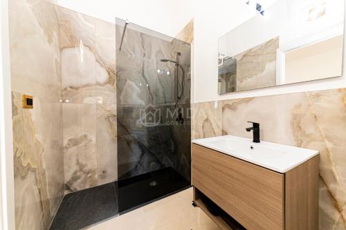 a bathroom with a sink and a shower at Dimora Due Mari in Salice Salentino